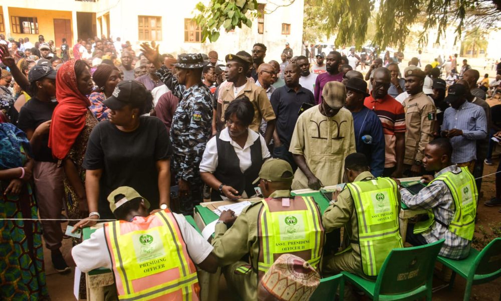 Voters wait on the queue to cast their votes