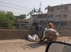 Scavengers set to dump refuse in a canal